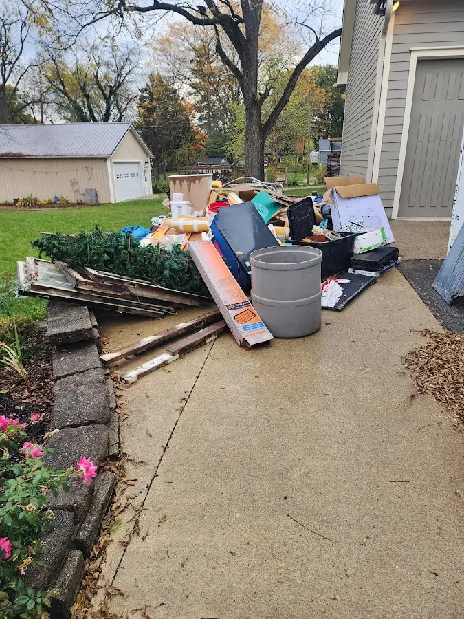 Dumpster being loaded with debris for Roofing Dumpster Rental in Grandview